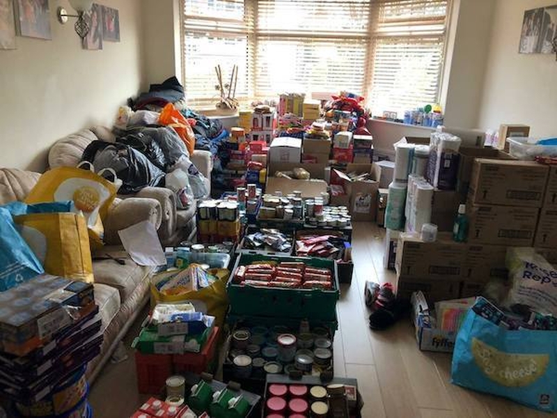 A Living Room Taken Over By Food Donations In Manchester