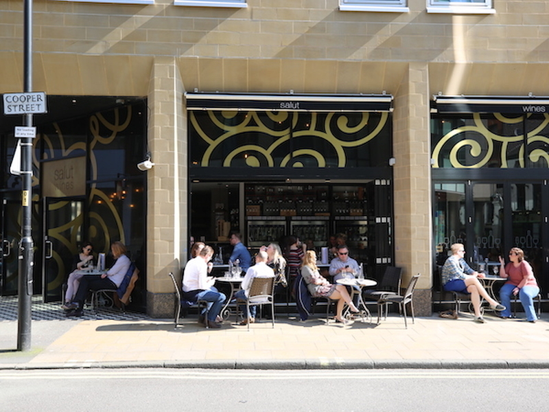 People Drinking Wine Outside Salut Wine Bar Before The Pandemic