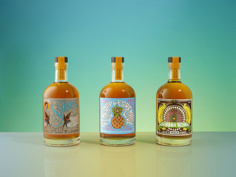 Three Bottles Of Rum From Rockstar Spirits On A Turquoise Background