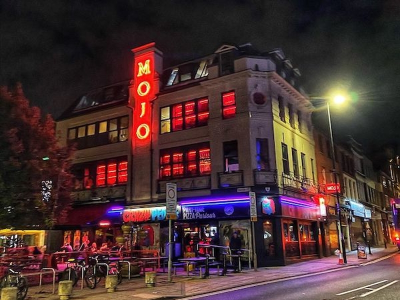 Mojo Bar And Club With Red Neon Sign And Lights At Night In Manchester