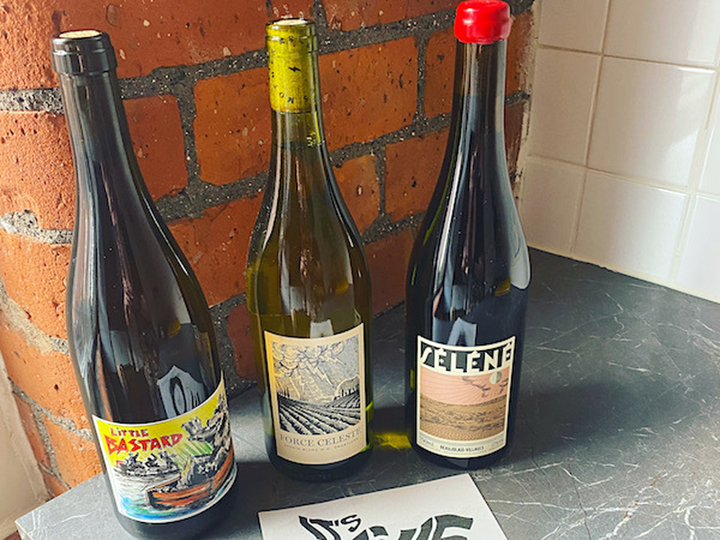 Bottles Of Natural Wine On A Brick Backdrop From Its Alive Wine Shop Manchester