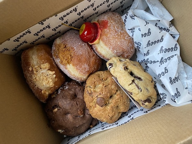 A Box Of Cookies And Doughnuts From Gooey Manchester