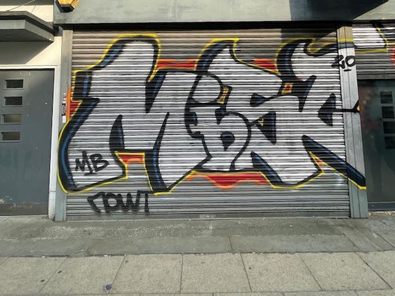The Graffitied Shutter Of The Unit That Was Toni And Guy But Will Be New Vhs Themed Bar Blcokbuster On Oldham Street In Manchester