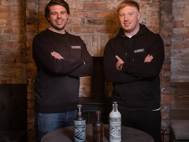 The Founders Of Salford Rum And A Selection Of Rum Bottles 1