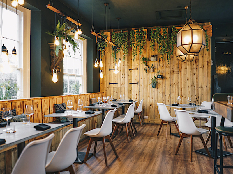 Interior At Hypha Restaurant Chester With White Chairs And Wooden Walls