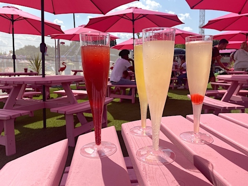 Sparkling Cocktails On A Pink Picnic Table Under Pink Table Umbrellas At Ourdoor Boujee Pop Up Trafford Centre
