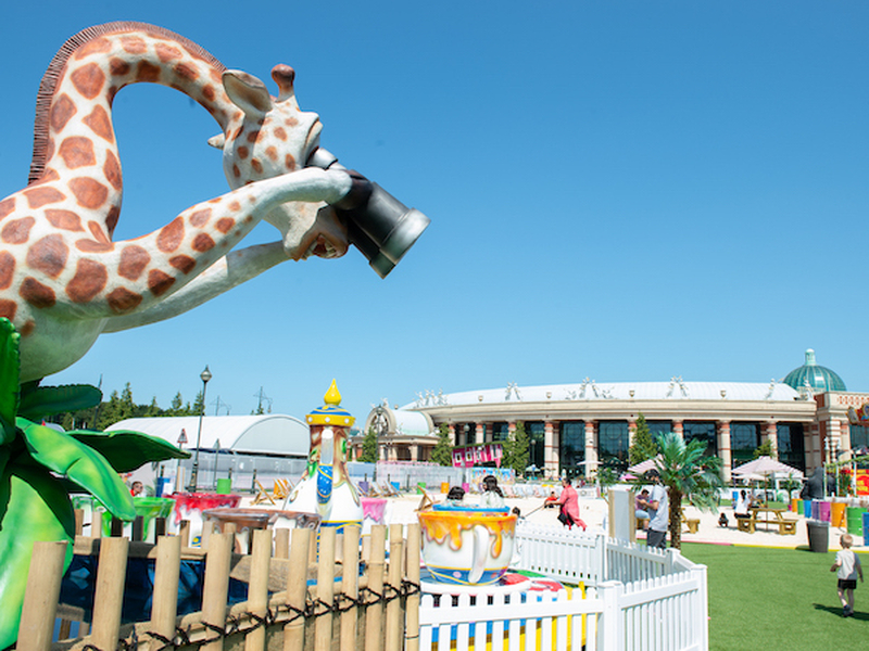 A Giraffe With Binoculars And Fairground Rides At The Trafford Centre Summer Social