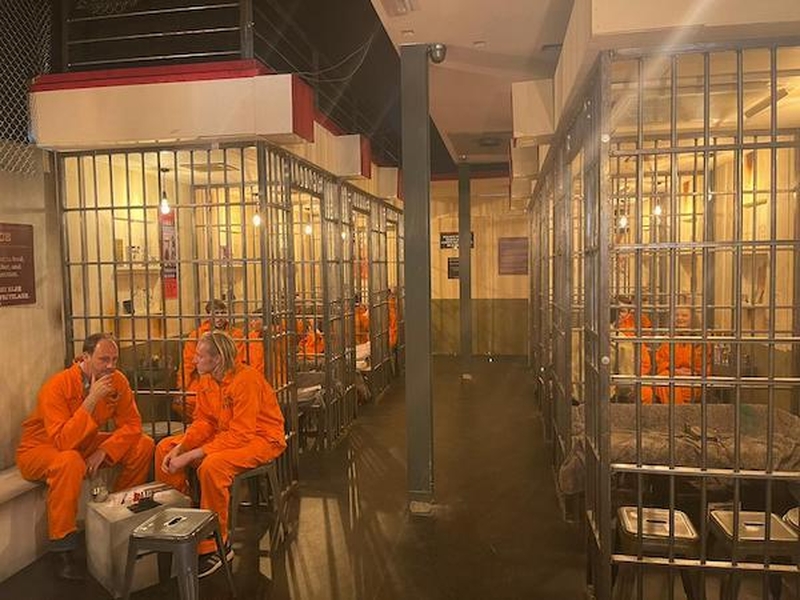 The Main Room And Cell Block Of The Alcotraz Immersive Cocktail Experience In Manchester Featuring Real Metal Bars And A Fake Toilet In Each Cell
