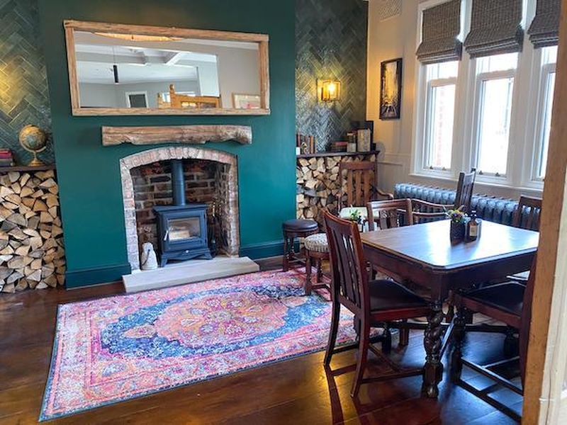 Refurbished Pub Area With Persian Rug And Wood Burning Stove At Black Friar Salford Greater Manchester