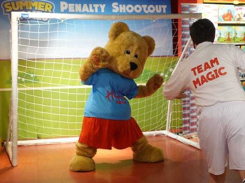 A Bear Goal Keeper Blocks A Goal From A Man Wearing A Team Magic Shirt At The Penalty Shootout Game At Hamleys Leeds Summer Of Fun Event