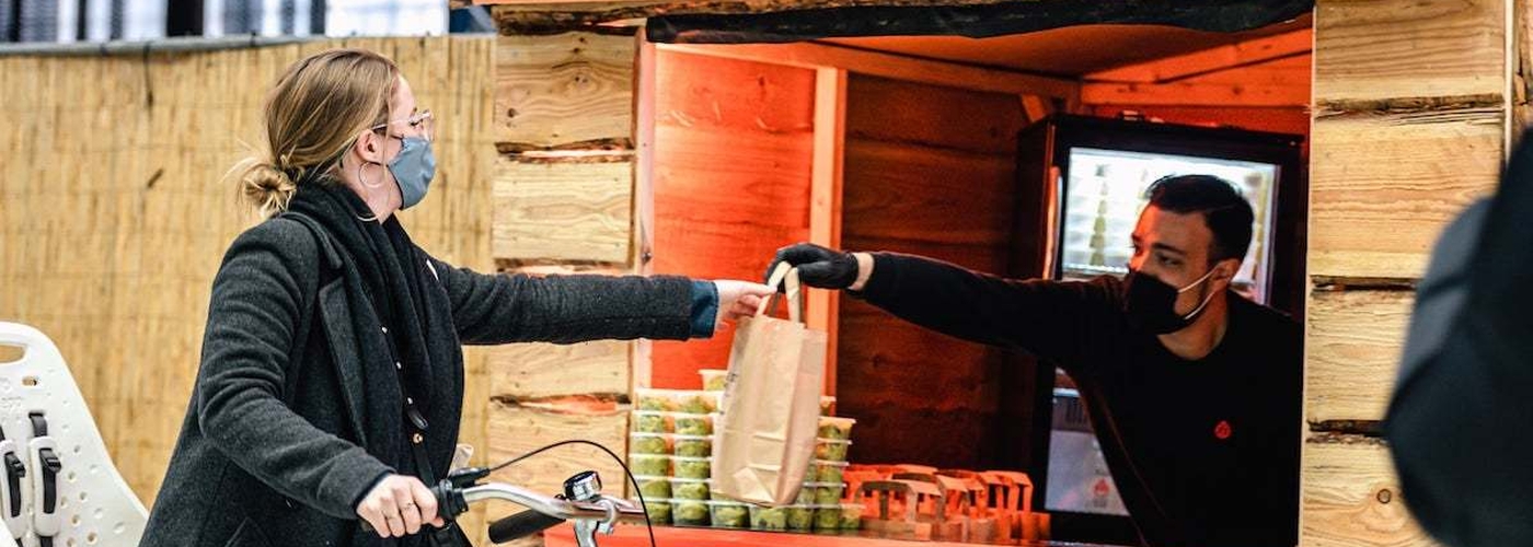 A Woman On A Bike Picks Up Her Order At Meatless Farm Barbecue Drive Thru