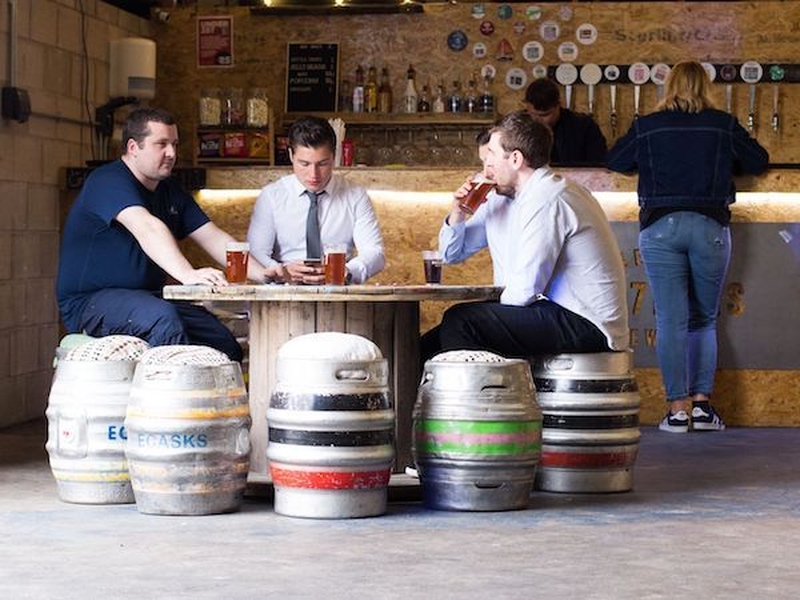 Men In Office Wear Drinking On Keg Chairs At Seven Bro7Hers Brewery Tap Room Manchester Salford