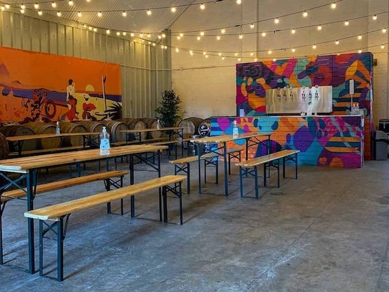 Beatnikz Republic Manchester Taproom Interior With Long Benches And Tables And Colourful Artwork