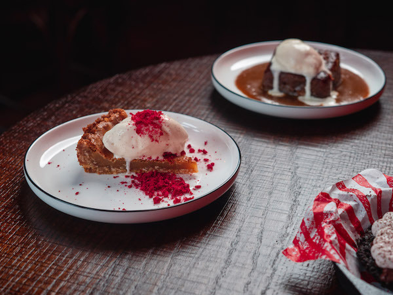 A Shot Of The Jimmys Manchester Crack Pie Dessert With A Sticky Toffee Pudding In The Background