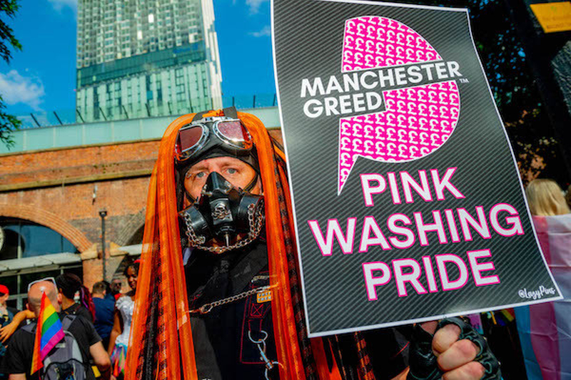 A Personin Cyber Goth Style Holds Pink Washing Pride Sign At Manchester Pride Protest 2021 Chris Keller Jackson