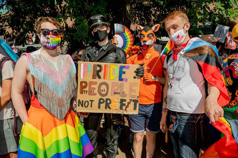 People In Masks And Rainbow Clothing Hold A Pride People Not Profit Sign At Manchester Pride Protest 2021 Chris Keller Jackson