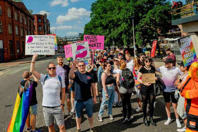 Pride Protesters With Signs Saying Pride Not Profit And Fund Safer Sex Packs Now At Manchester Pride 2021 Chris Keller Jackson