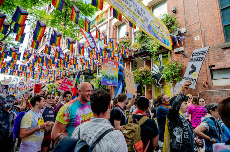 Protesters Holding Signs March Under Rainbow Flags At Manchester Pride Protest 2021 Chris Keller Jackson