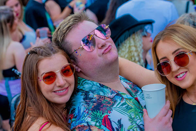A Man In Haiwaiian Shirts Pouts With Two Smiling Female Friends Wearing Sunglasses At Manchester Pride 2021 Chris Keller Jackson
