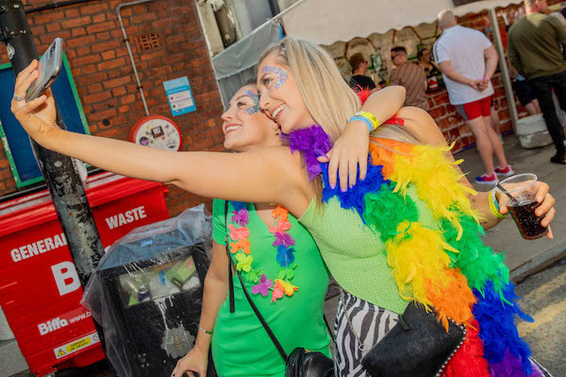 Girls With Rainbow Feather Boa Take A Selfie In From Of A Large Red Bin At Manchester Pride 2021 Chris Keller Jackson