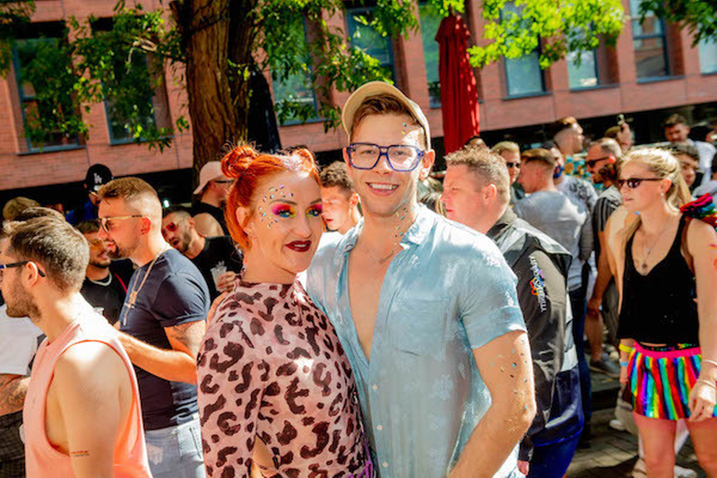 A Woman With Rainbow Eyeshadow And Leopard Print Top And Male Friend In Blue At Manchester Pride 2021 Chris Keller Jackson