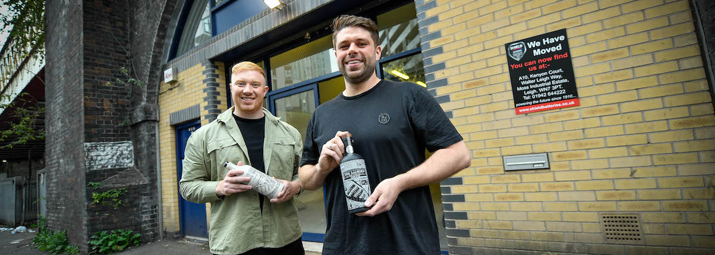 Salford Rum Founders Tommy And James Holding Bottles Of Their Salford Born Rum On Viaduct Street In Manchester