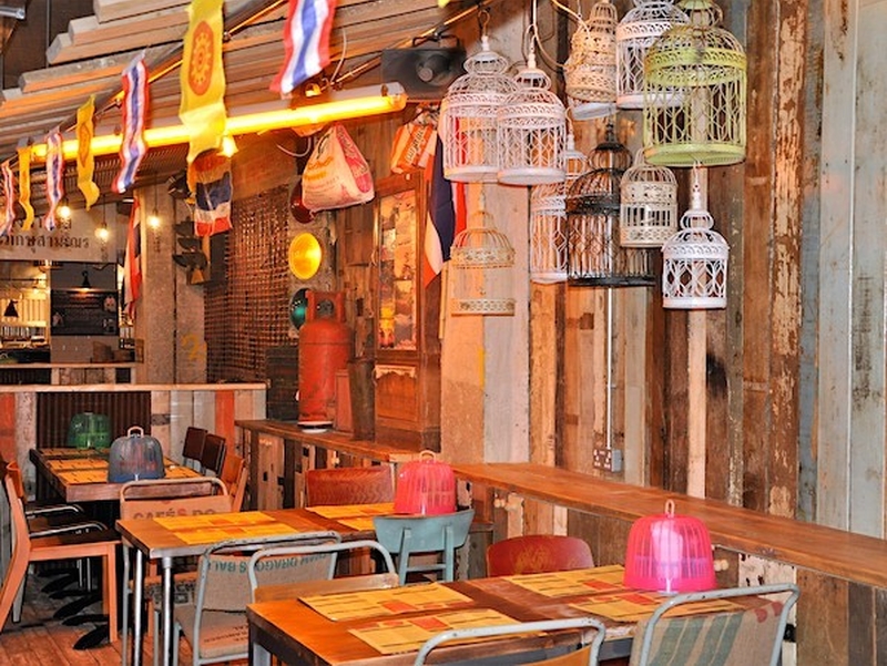 Thaikhun Interior With Hanging Lanterns Thai Flags And Wooden Tables