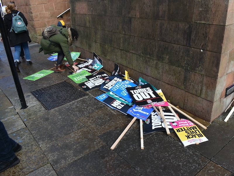 Signs And Placards At Castlefield Bowl After The March Against The Tory Conference In Manchester