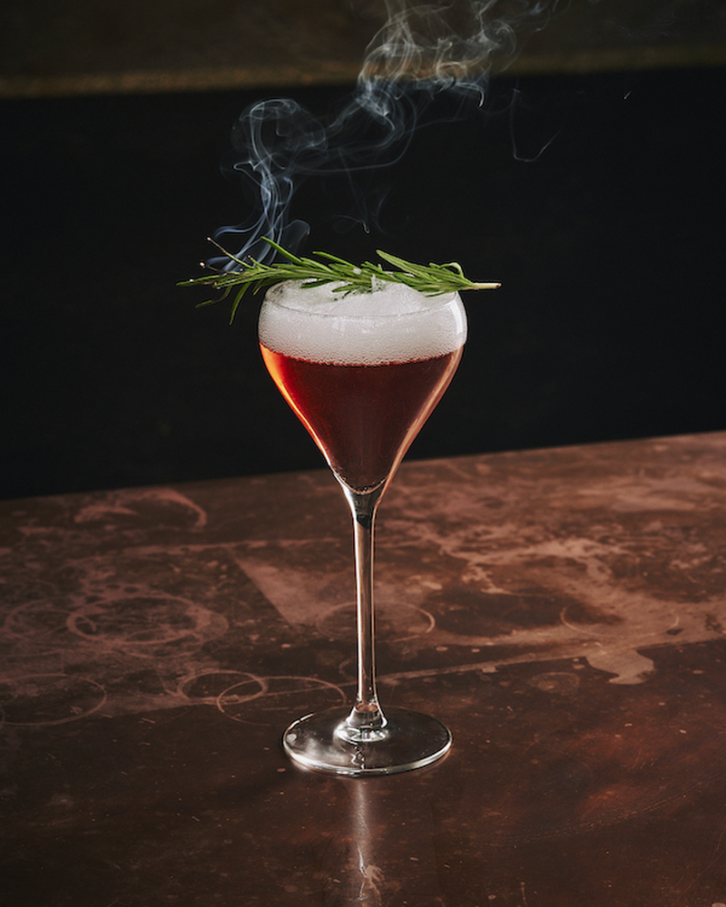 Full Size All The Trimmings Xmas Dinner Cocktail With Rosemary Sprig And Wisp Of Smoke From The Alchemist New York Street Manchester