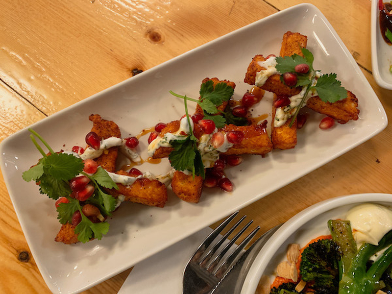 Fried Halloumi With Pomegranate Seeds And A Tahini Sauce At Off The Grid In Chorlton Manchester Uk