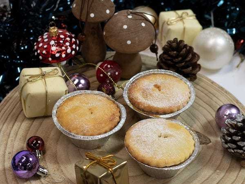 Mince Pies An A Wooden Board With Baubles And Fairy Lights Surrounding