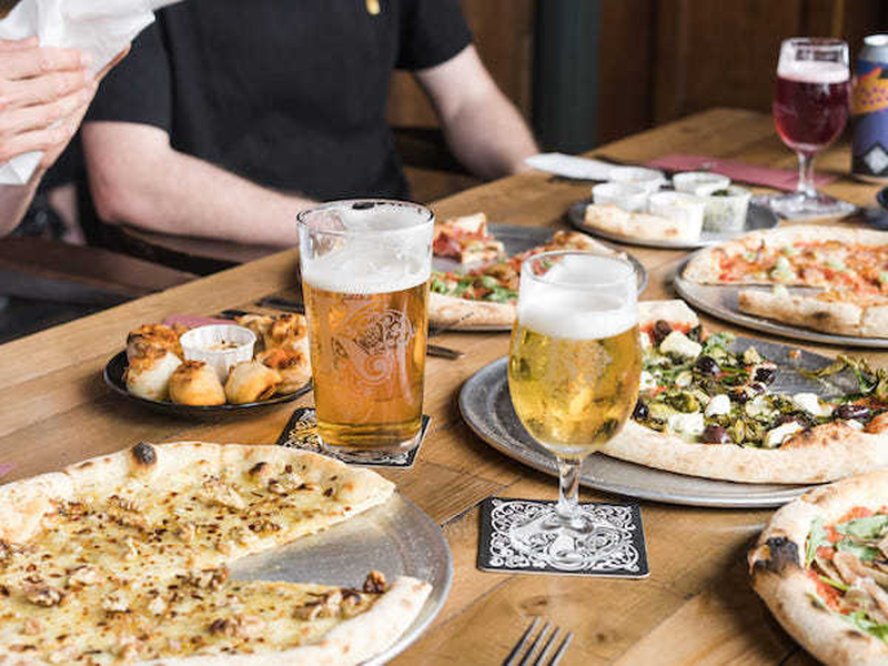 Kirkstall Brewery Beer And Pizza On A Table