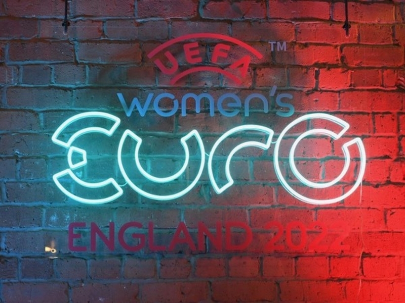 Neon sign on a brick wall promoting the UEFA Women's Euros 2022