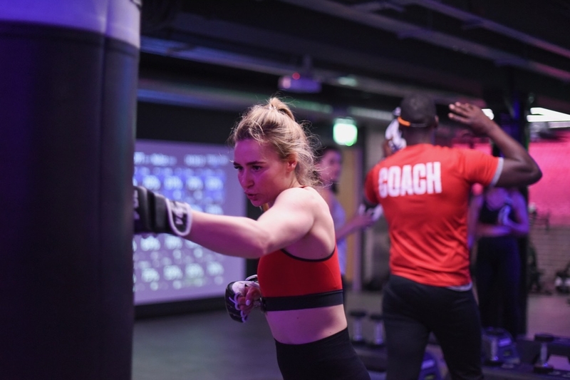 Girl hitting a punch bag at a V1BE boxing class