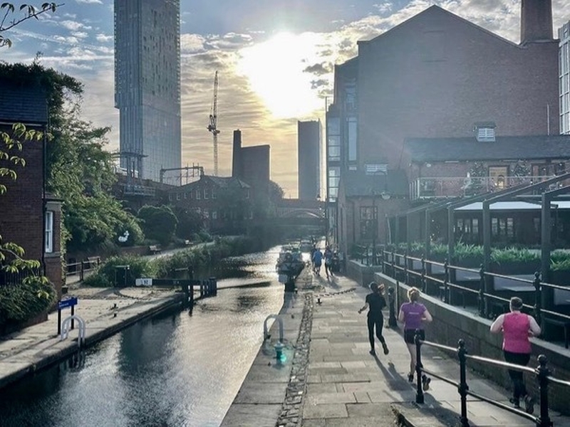 Runners with canal and Beetham Tower