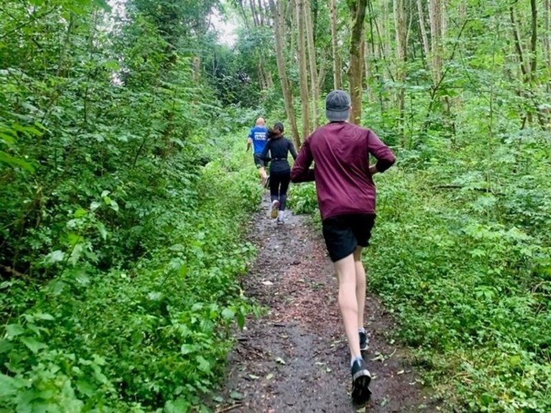 Runners in woodland in Manchester
