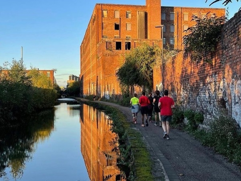 Two runners by a canal in Manchester.jpg