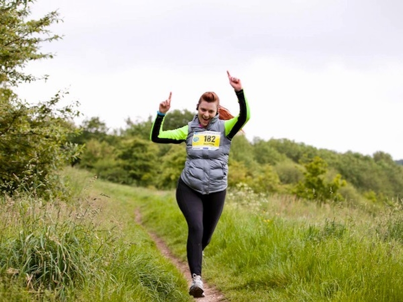 Girl trail running at the Tour of Tameside running festival in Greater Manchester