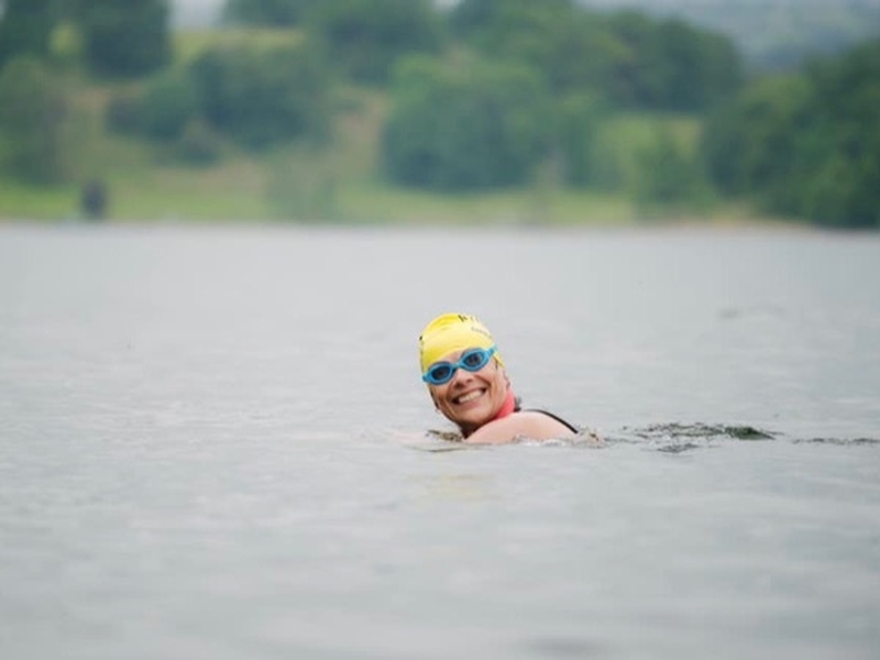 Woman taking part in the Great North Swim at Windermere in the Lake District