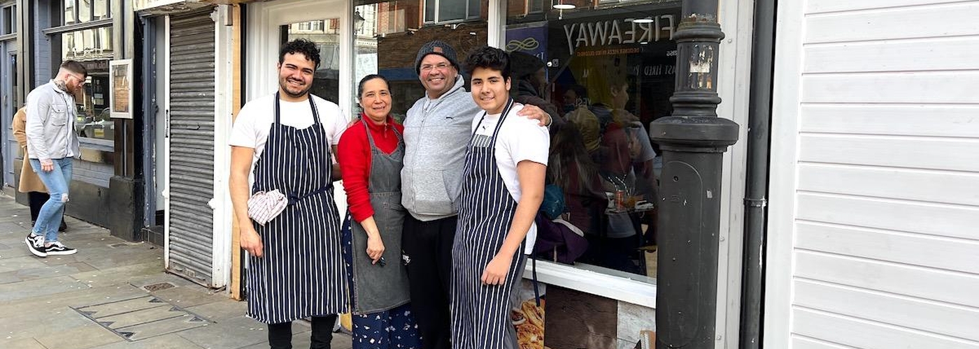 The Sanjuan Family Outside Their Colombian Cafe In Stockport