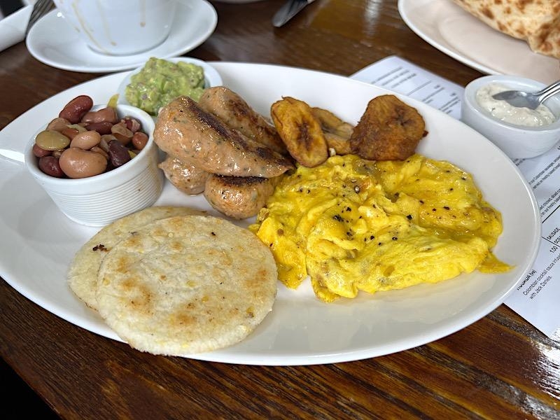 Colombian Full Breakfast With Perico Eggs Spicy Sausage Beans And Arepas At Cafe Sanjuan Stockport