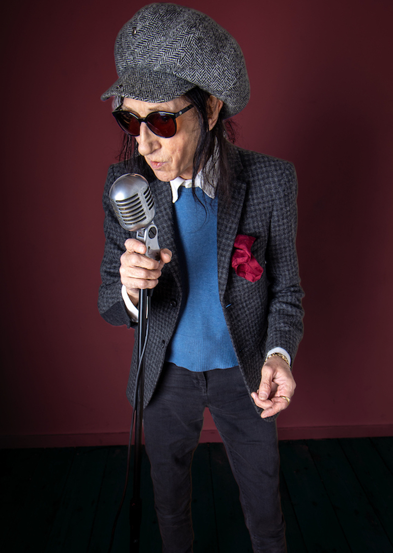 John Cooper Clarke Holding An Old Fashioned Microphone