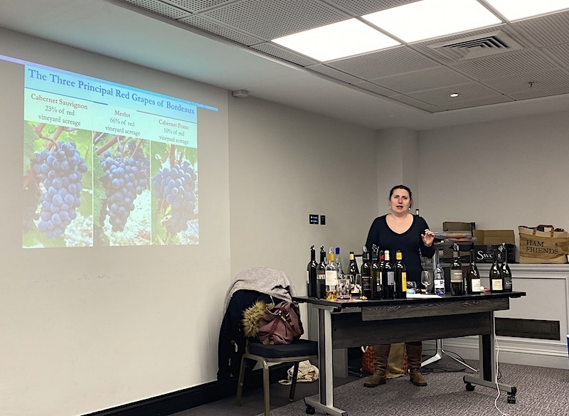 Laura Kent Surrounded By Wine Bottles Teaches About French Wine In Leeds