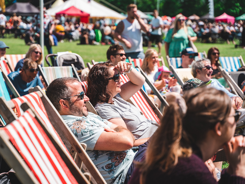 Punters Sit On Deck Chairs At Heaton Park Food Festival In Manchester