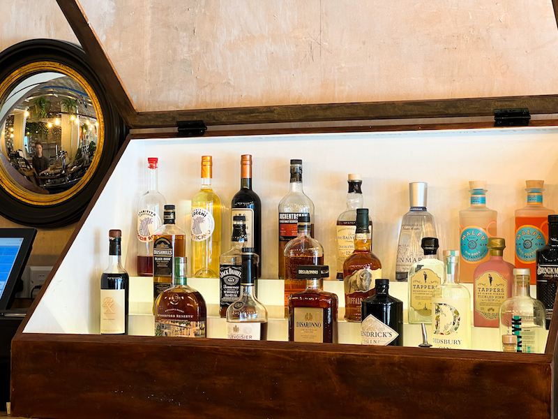 Drinks Cabinet With Selection Of Spirits And Bottles At Greens In Sale