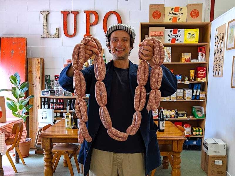 Lupo Owner Nico Holds Up Some Sausages At His Prestwich Cafe