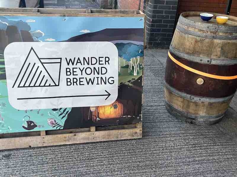Wander Beyond Sign Next To The Taproom In Manchester