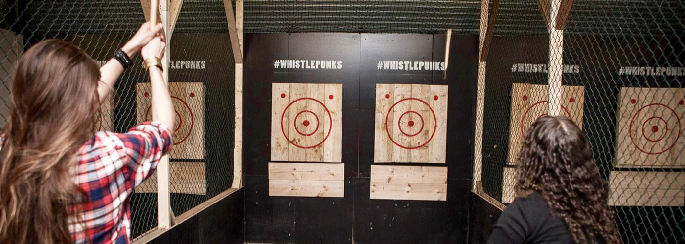 Two girls at axe-throwing centre Whistle Punks in Manchester's Great Northern
