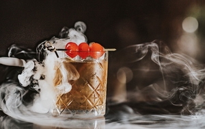 A Cocktail With Dry Ice And A Skewer Of Cherries At Rendition Bar Manchester