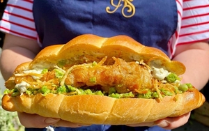 A Person Holding An Enormous Fish Finger Butty From Alberts Schloss Manchester